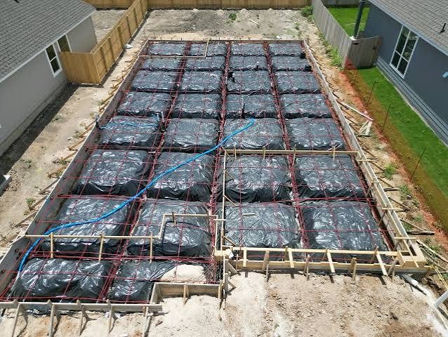 Pre-pour phase foundation inspection showing rebar, post-tension cables, and vapor barrier in Houston