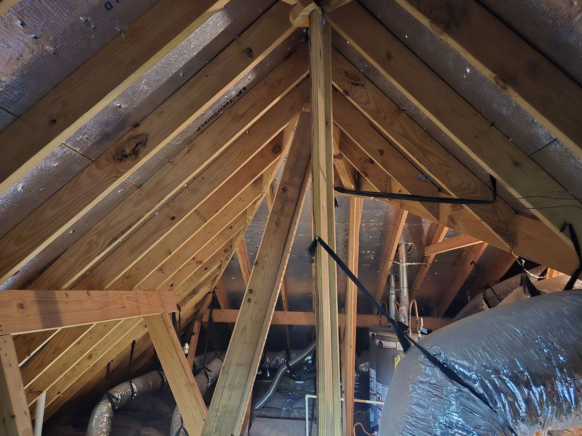 Attic rafters, roof decking, and insulated flexible ducts photographed during a home inspection in Oak Forest, Houston