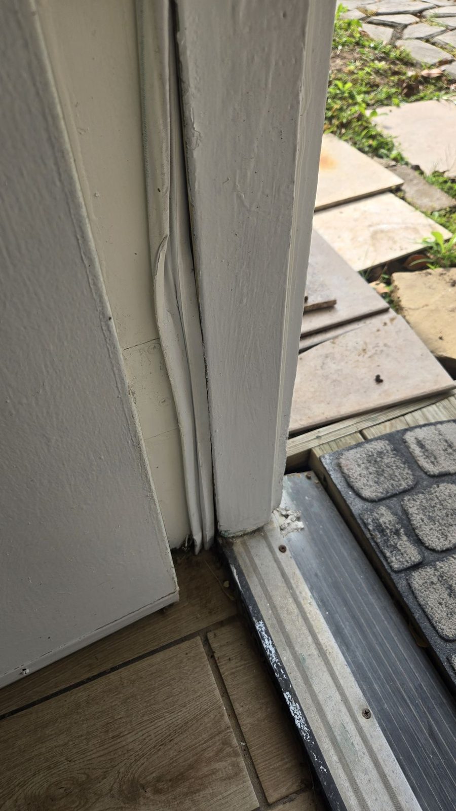 Cracked and separated exterior door trim at an entry photographed during a Sugar Land, Texas home inspection