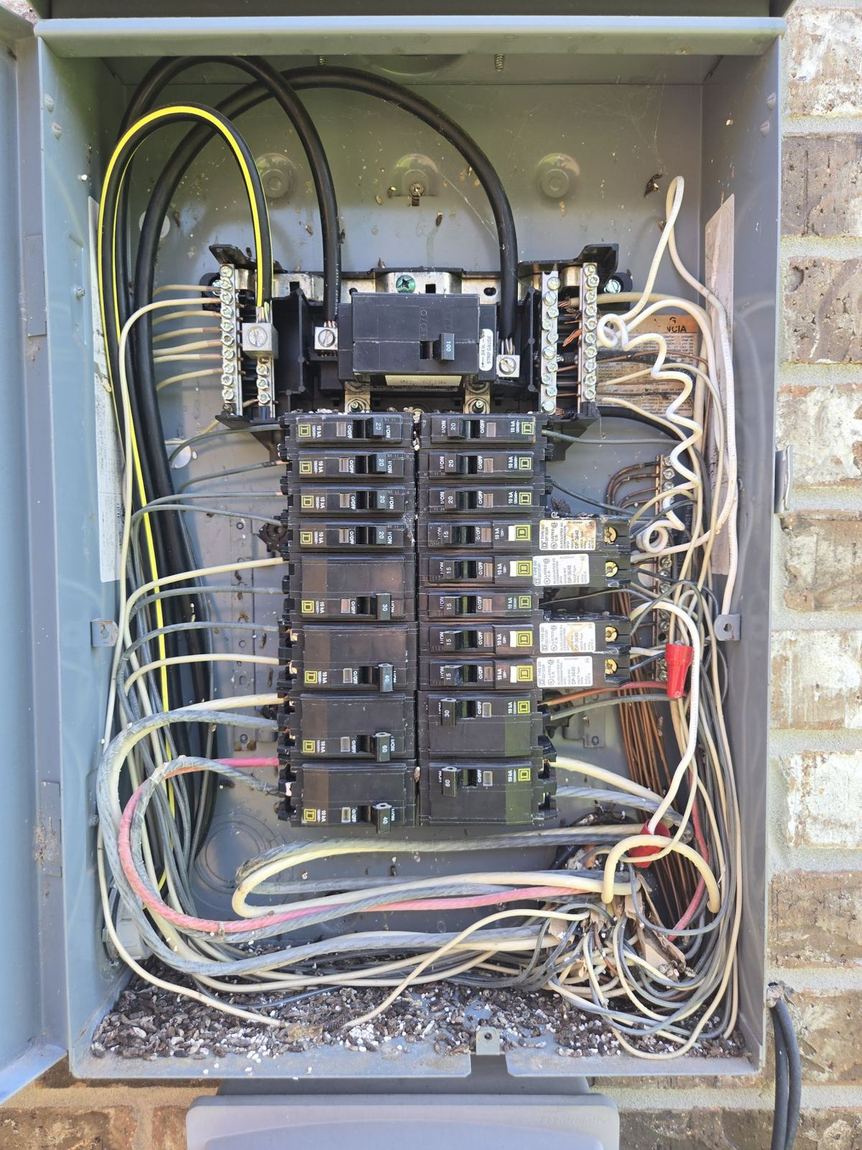 Open electrical panel with breakers and branch wiring photographed during a Willis, Texas home inspection